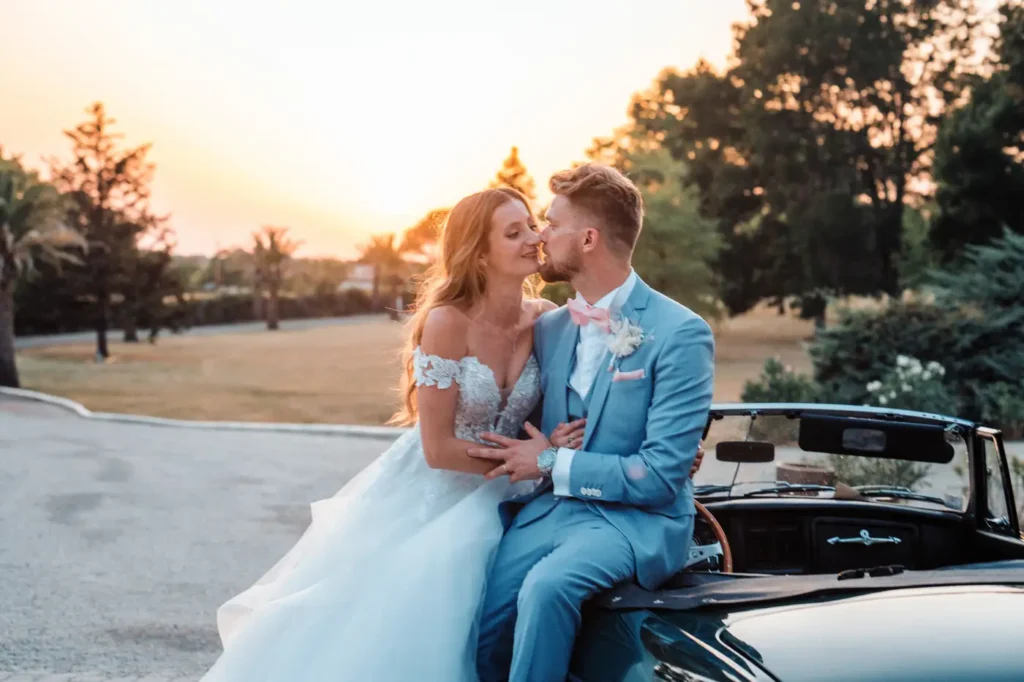 Mariés assis devant le château au coucher du soleil