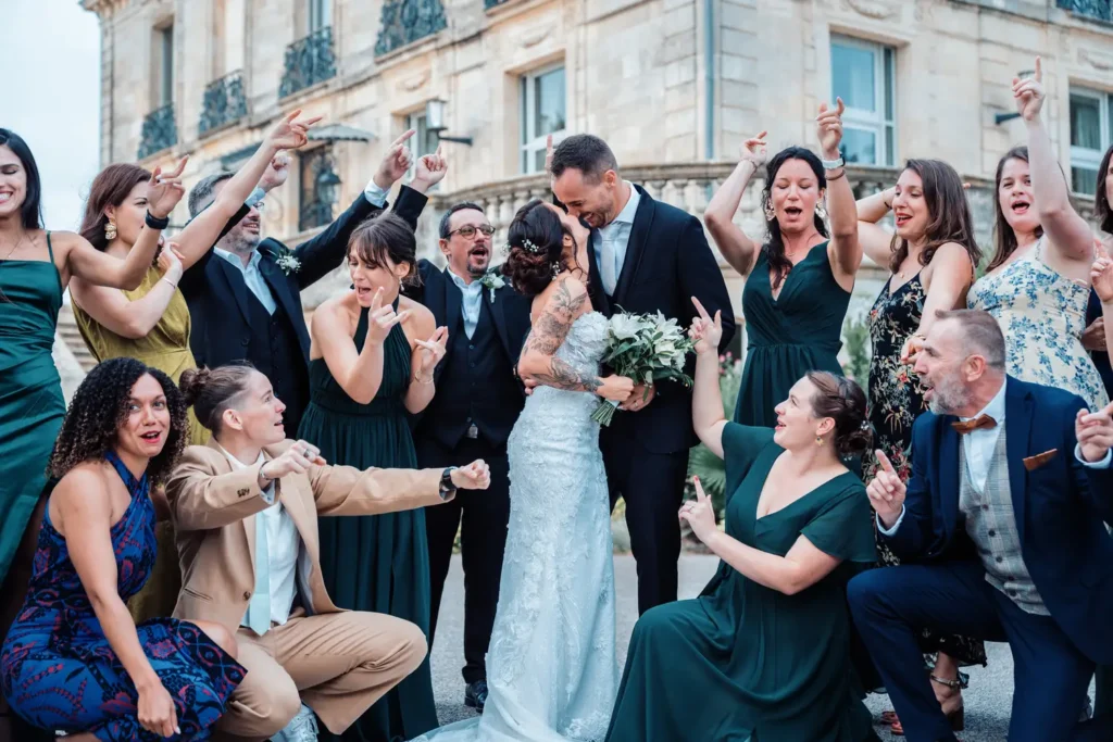 Photo festive des témoins et des mariés devant le château