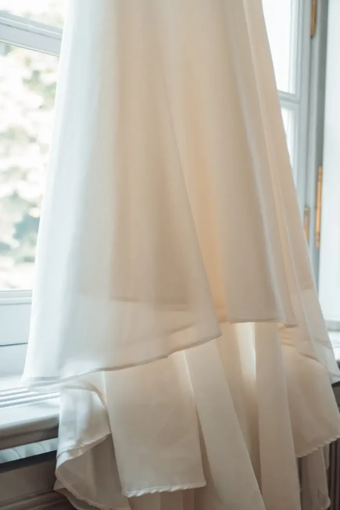 Robe de mariée suspendue dans une chambre du château
